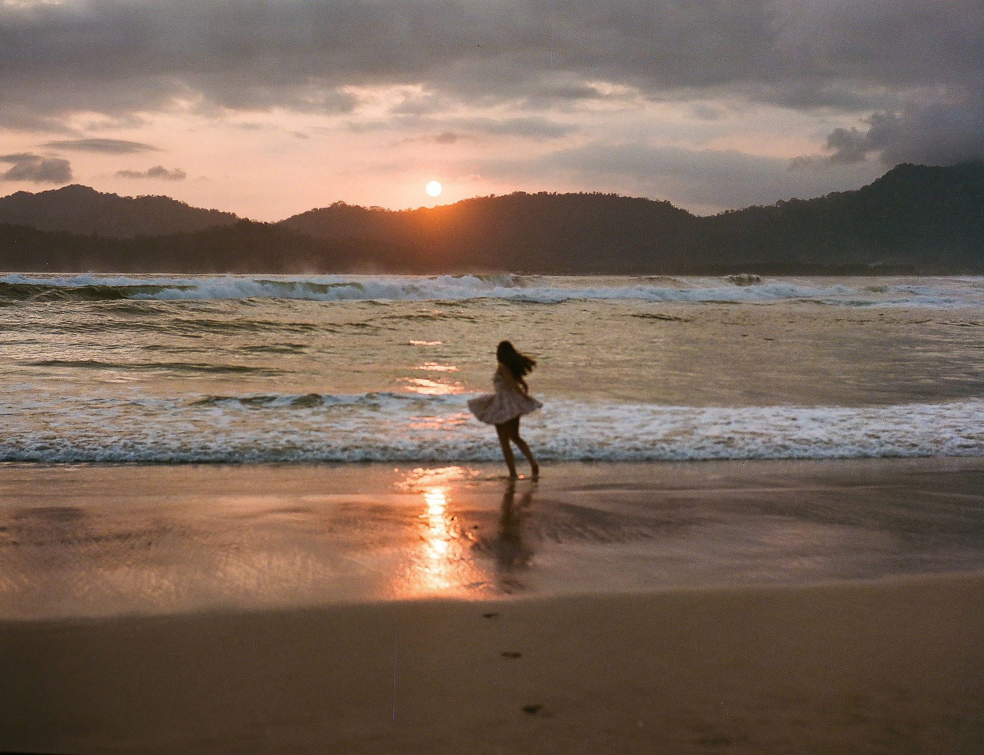 A women enjoying sunset on the beach