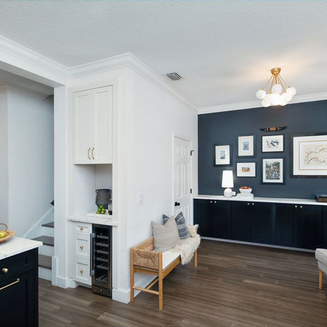 Stylish transitional living space with black built-in cabinets, gallery wall, and a custom coffee and wine bar nook, remodeled by Moll & Co. | Vista in Tampa, FL