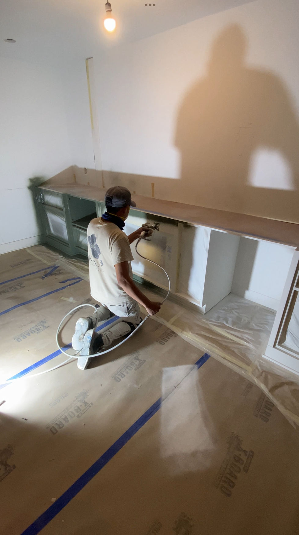 Kona house painter painting cabinets in Edina home