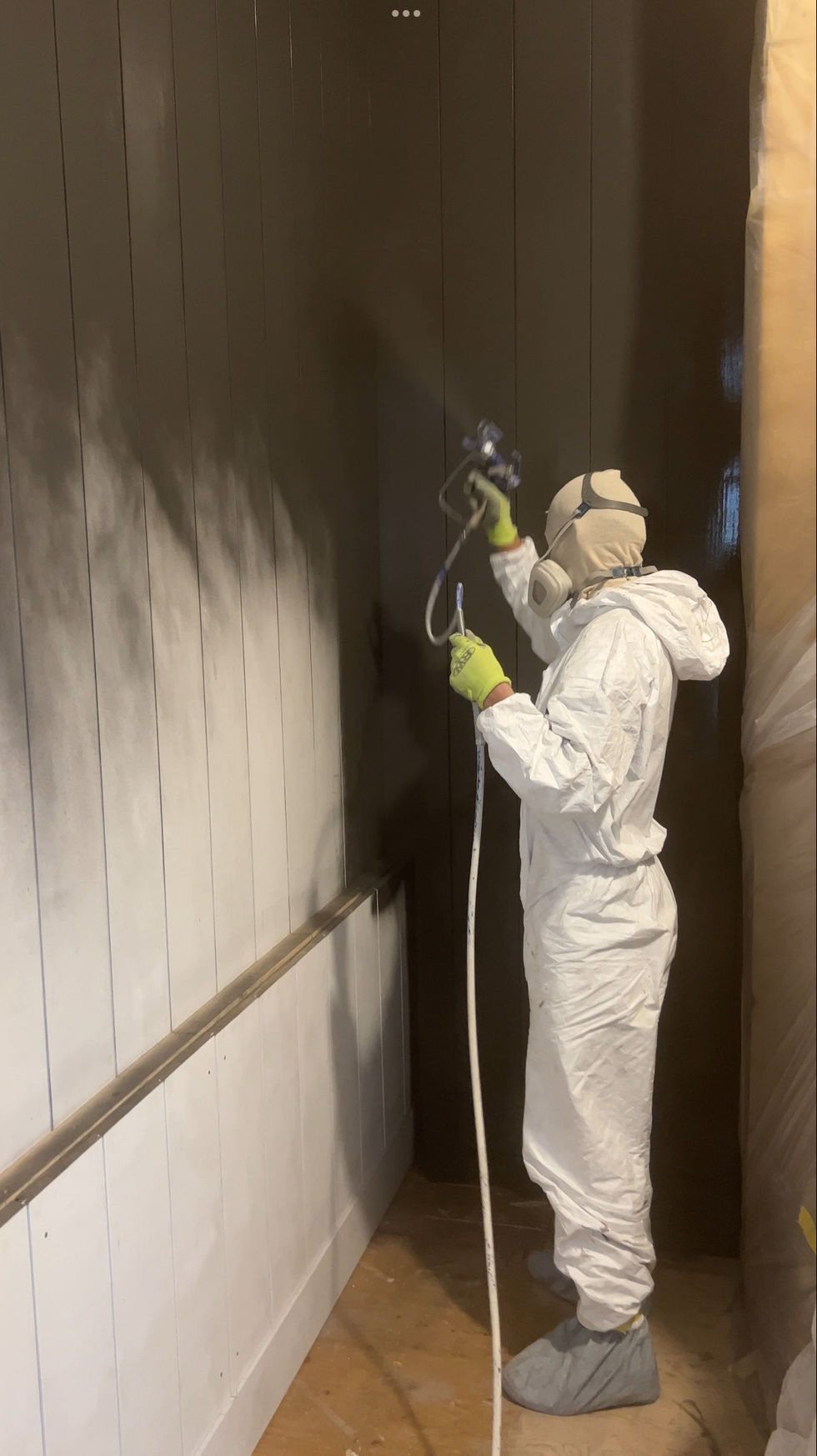 Interior painter spraying shiplap in Edina home