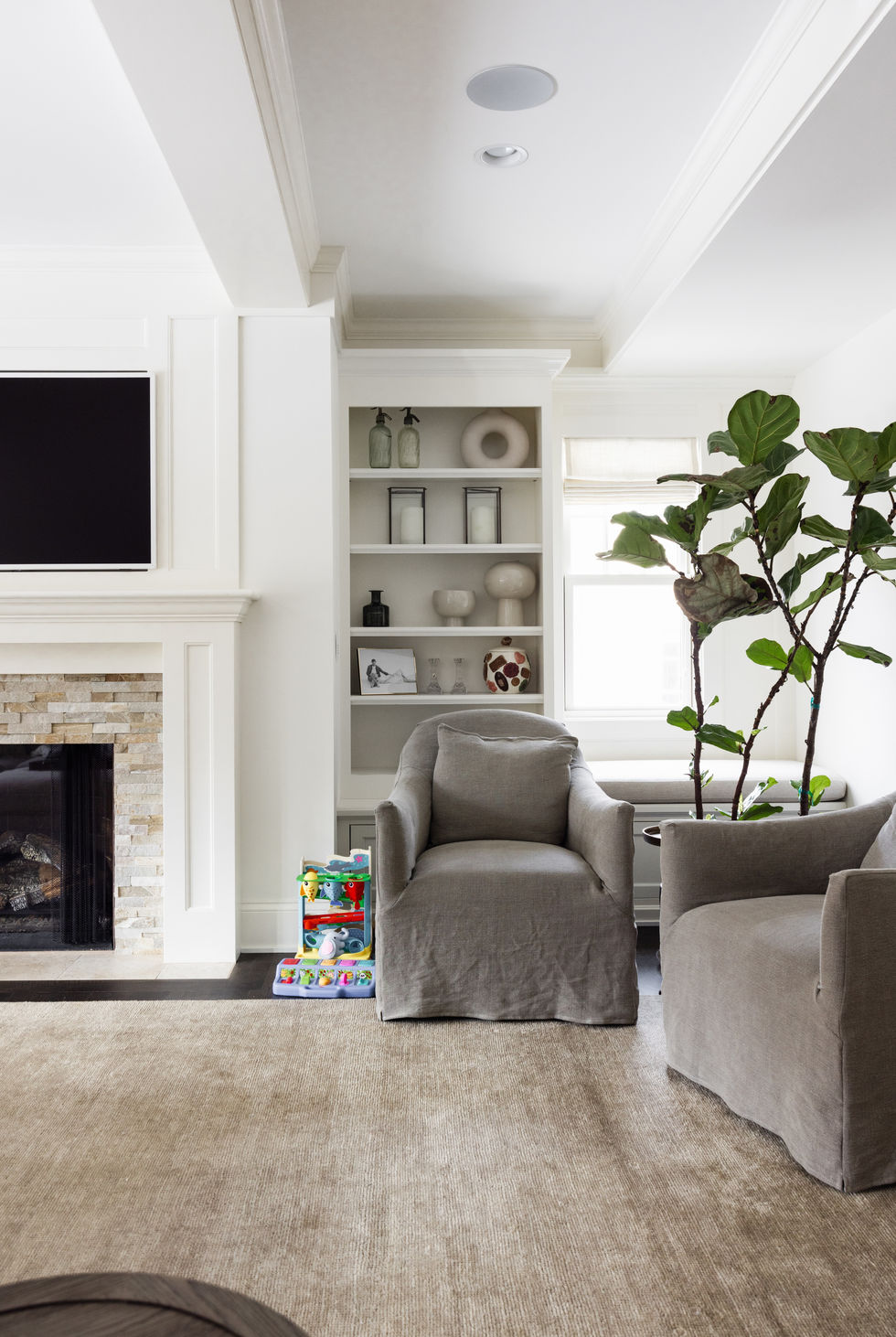 Edina Minnesota custom white painted ktichen with metal range hood, dark refinished wood floors, double ovens, commercial stainless range, island, raised tray ceilng with custom painted crown molding.