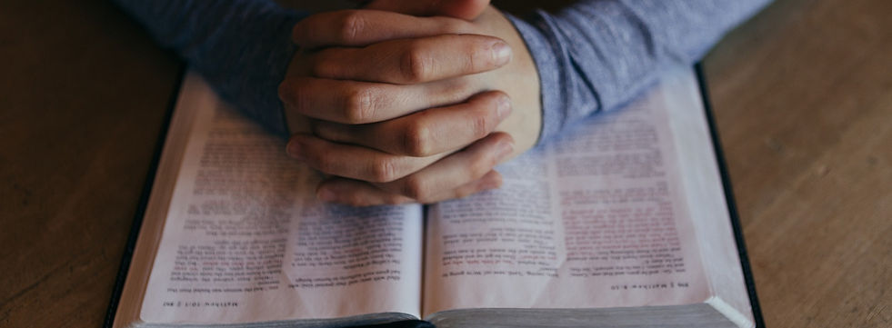 person praying at bible study
