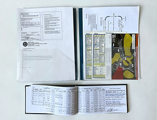 Pilot logbook and clear plastic file containing various paperwork