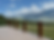 Custom wood deck railing with Montana mountain views, designed for durability and complementing a log home exterior.