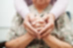 someone holding and cupping and elderly persons hands
