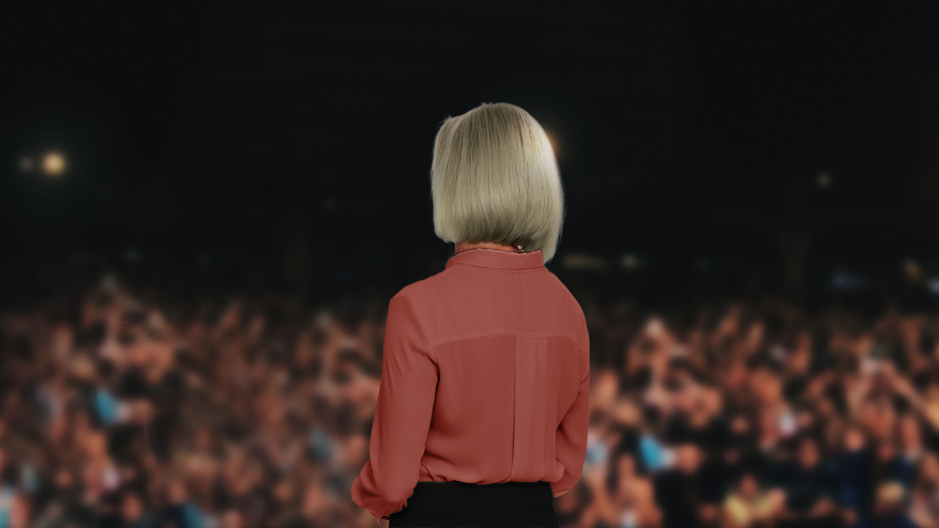 blonde woman in red shirt presenting to leaders