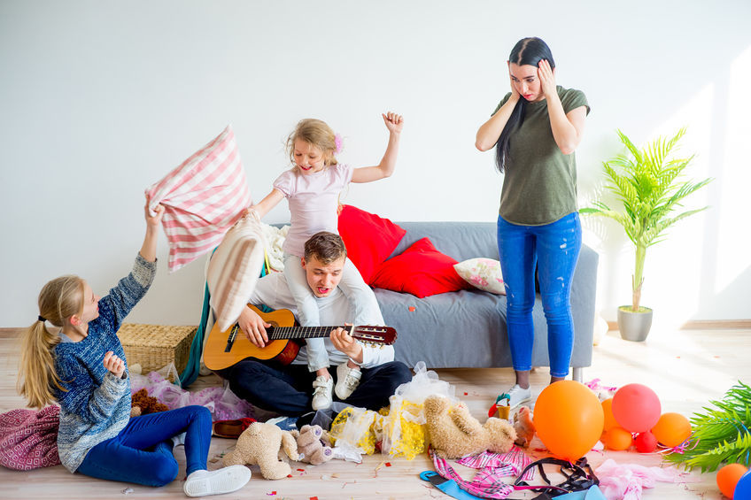 Stressed mom with kids in messy house