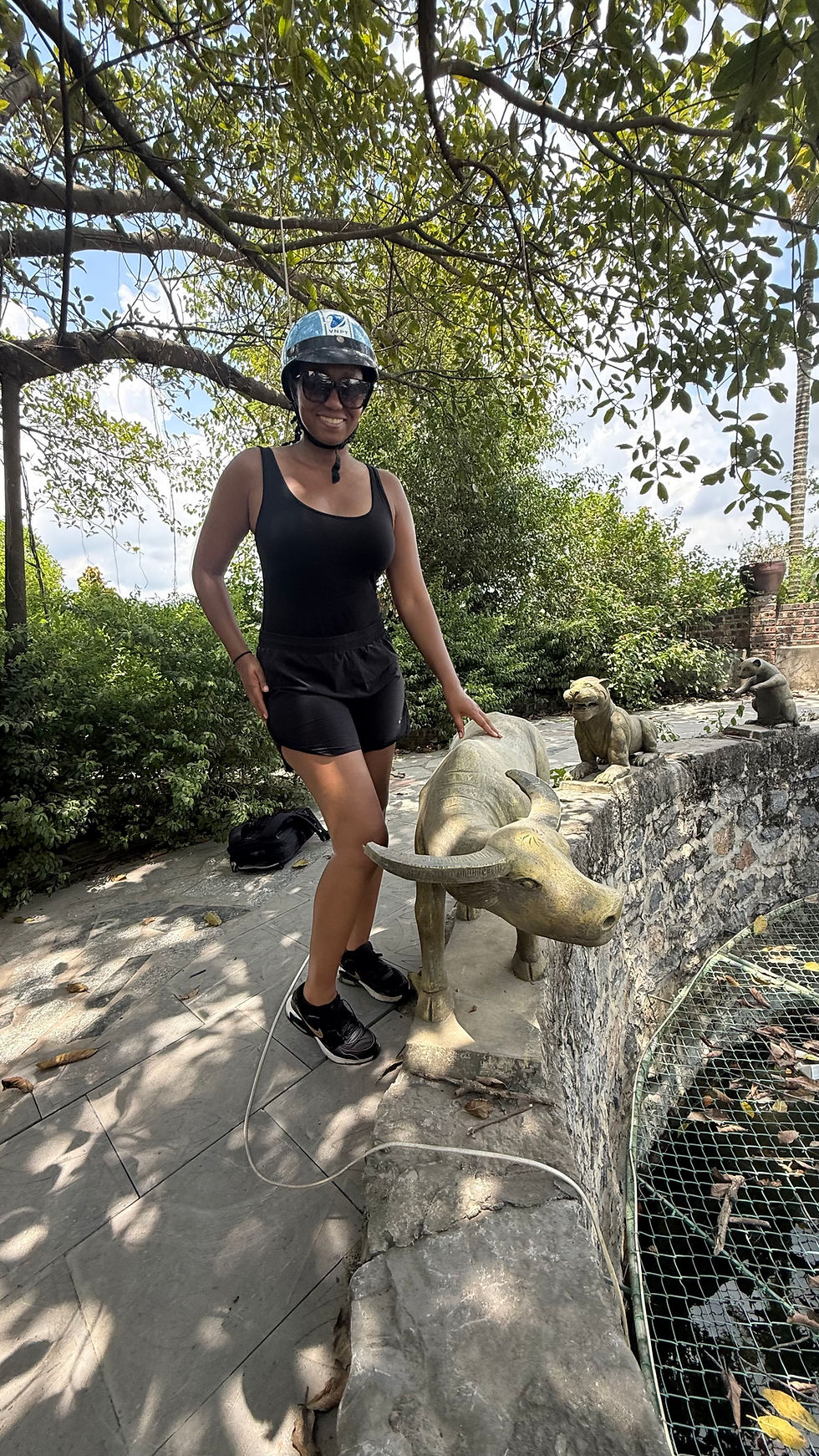 Photo of Gina in front of statues of the Chinese Zodiac in Ninh Binh, Vietnam