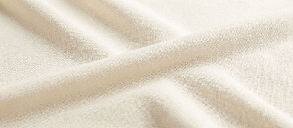 Close-up of soft, cream-colored fabric with gentle folds