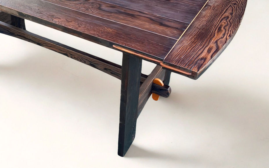 Handcrafted rustic reclaimed Douglas fir dining table with trestle base, Shou Sugi ban finish, detail view of splines and trestle base