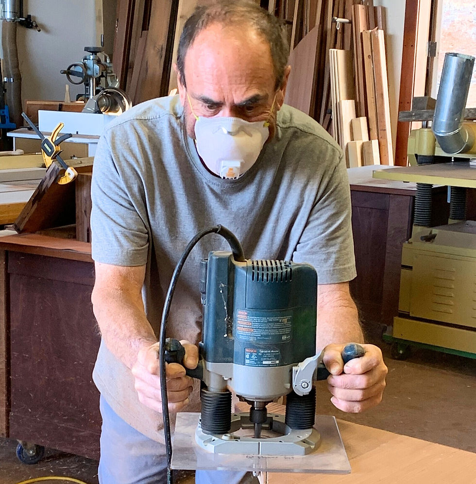 The maker in his shop working with a router