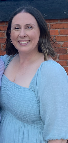Therapist, Siobhan McPartland, smiling wearing a blue sundress