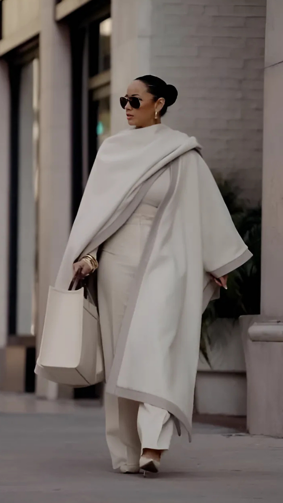 Woman in winter outfit walking down street