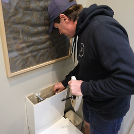 Melbourne plumber performing routine plumbing maintenance and inspection under kitchen sink