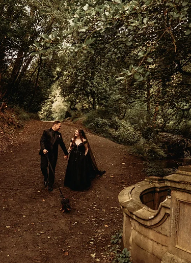 Alternative couple on their wedding day. Walking in the woods.