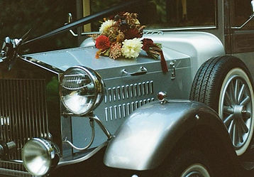 Wedding car with flowers on the bonnet.
