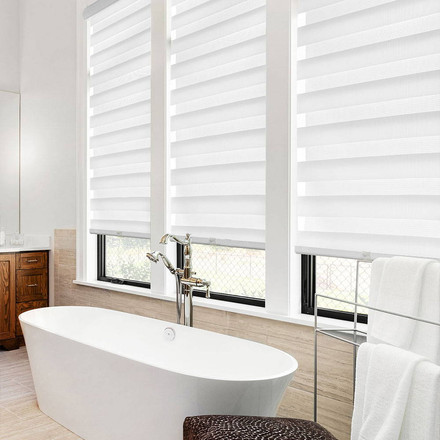 White zebra blackout blind installed in a modern bathroom window