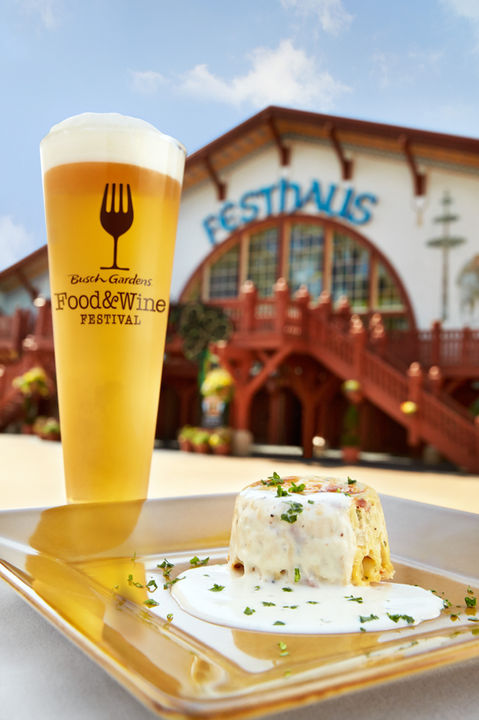 A frosty beer and savory tapas dish seen against the Festhaus as part of a culinary event at Busch Gardens Williamsburg in Virginia.