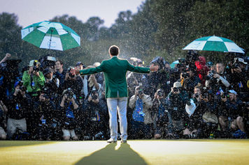 A dramatic sports portrait of Adam Scott celebrating in the rain after winning the 2013 Masters golf tournament in Augusta, Georgia.