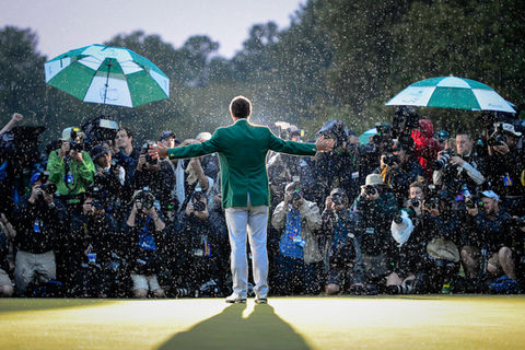 A dramatic sports portrait of Adam Scott celebrating in the rain after winning the 2013 Masters golf tournament in Augusta, Georgia.