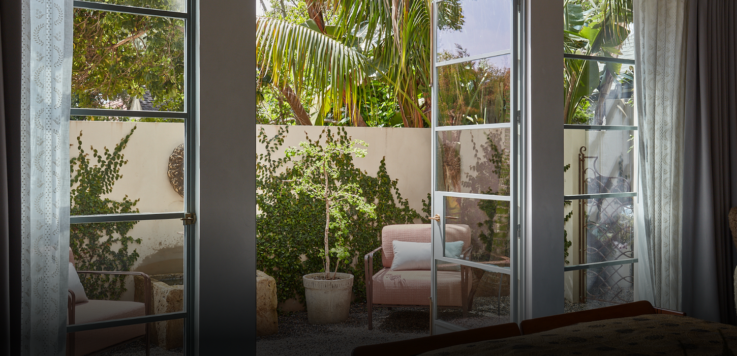 Private patio oasis, lush greenery, comfy chairs