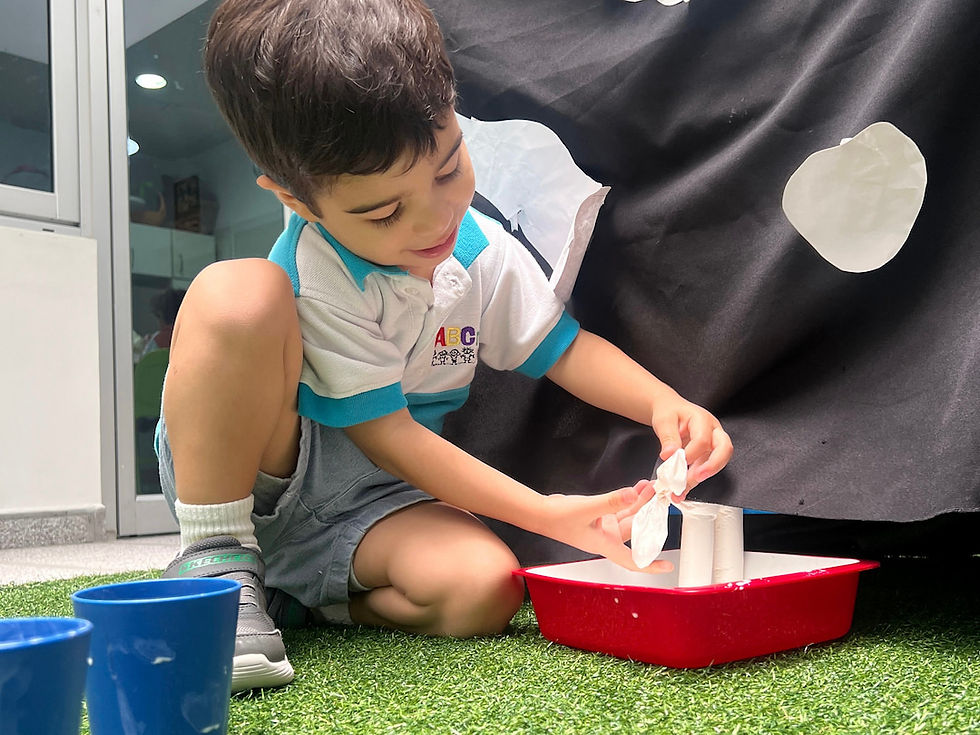 Child learns through play by pretending to milk a cow at ABCnMe Preschool in Costa del Este, Panama.
