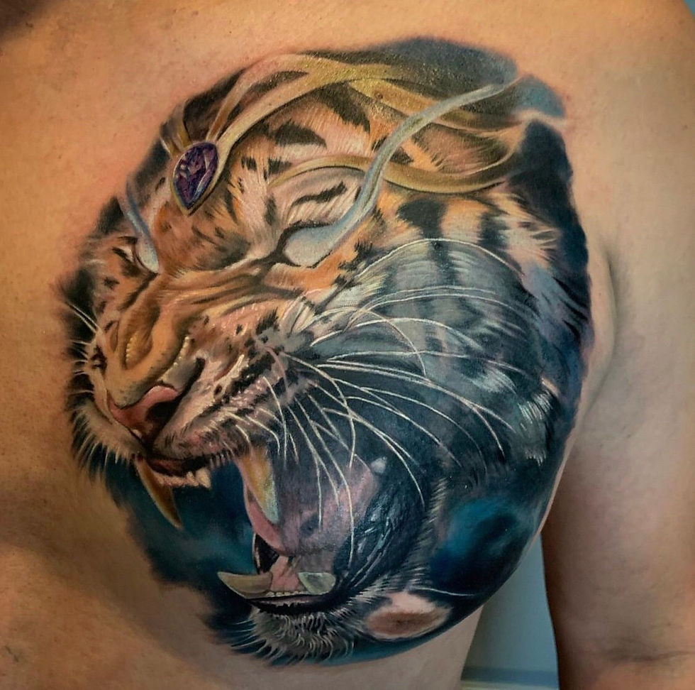 Detailed roaring tiger head tattoo with a jewel on its forehead.