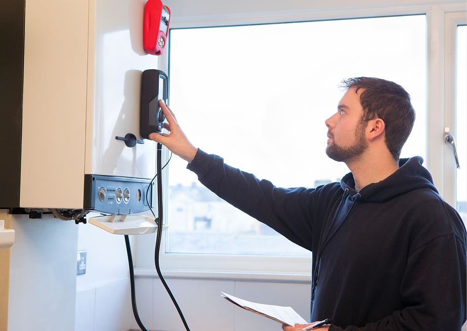 Plumber inspecting a boiler and reviewing paperwork during a professional service visit in Erskine.