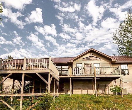The back of the guest house has a deck facing the sunset