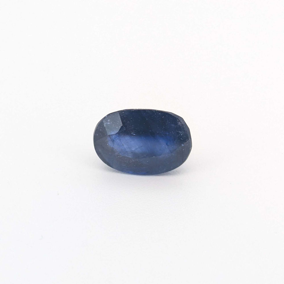 Brilliant cut natural blue sapphire jewelry gemstone, perfect for an engagement ring, showcased on a seamless white surface.