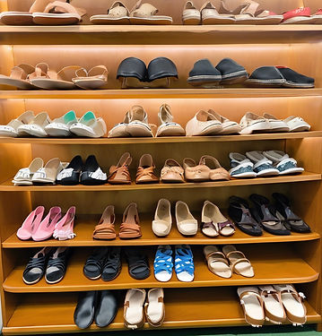 row of shoes, sandals, sneakers, boots, etc for sale.jpg