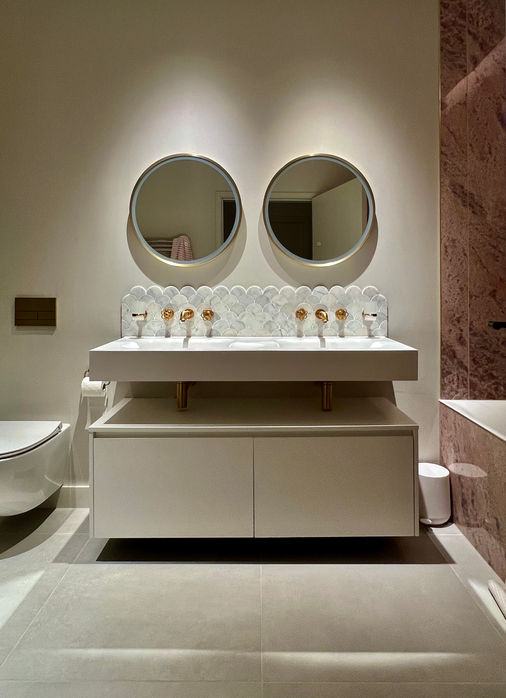 Modern family bathroom. Vanity with mirrors above, 3m tiles to bath alcove gold
