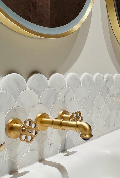 Modern family bathroom. Vanity with mirrors above details pink gold