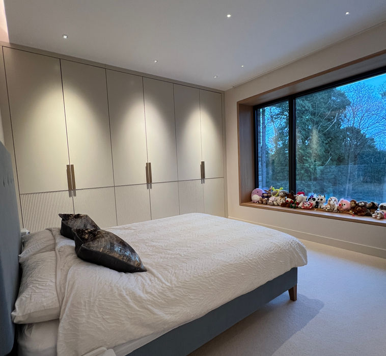 Light filled bedroom with in-built storage and lighting design