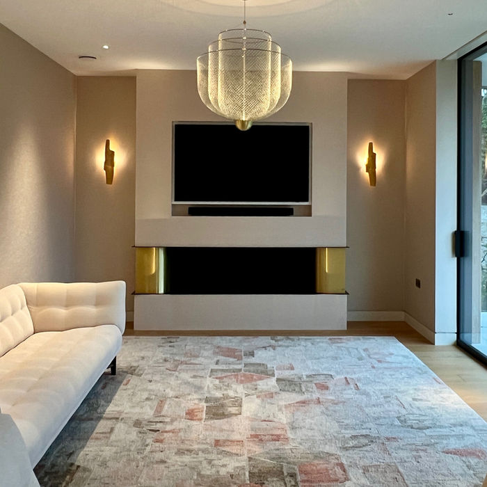 Sitting Room custom fireplace with brass side panels and ecofire, this room has a muted pink and gold colour palette, with iconic light fittings and furniture.