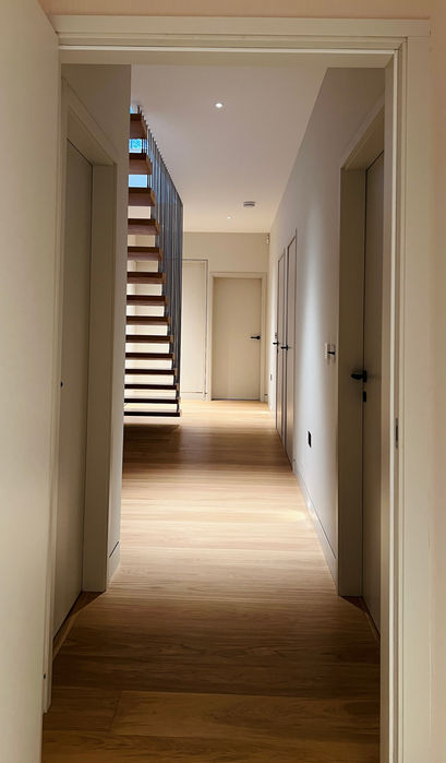 New suspended modern oak staircase rear view, and corridor lighting.