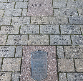Engraved memorial bricks with names and dates.