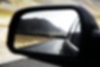 Car mirror representing time to look back, reflect, and tackle a mid-year reset