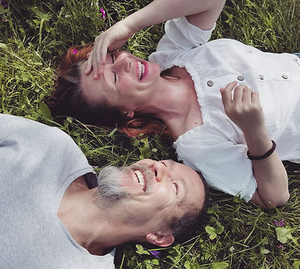 The Drunken Monk team Peter and Vewro giggling on the grass on a Meditation and Yoga Retreat