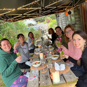 Surf yoga women only retreat guests having dinner together at the luxury yurt village