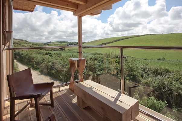 Accomodation for surfing retreat in Cornwall with a Balcony with lush green views.