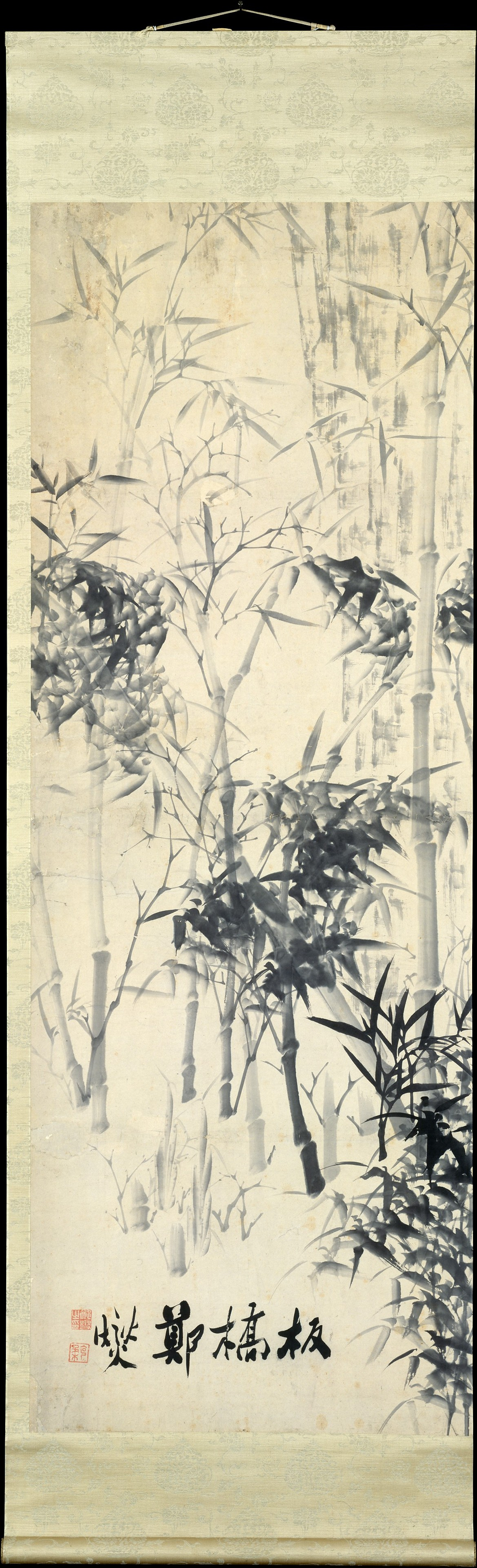 Ink bamboo painting on a hanging scroll with Chinese calligraphy and red seals, in soft gray tones on a cream background.
