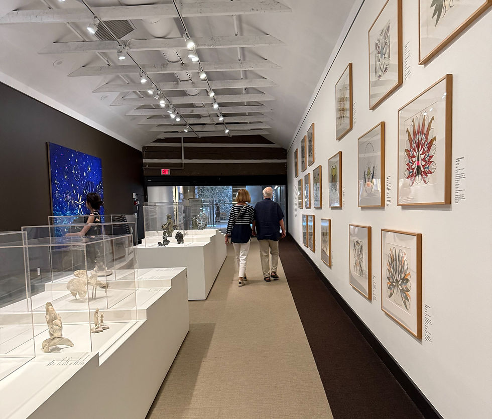 Lori and Roald walking through the indigenous and Inuit collection. Painting on left by Landon Mackenzie, Simulator-Neurostar, 2012, oil on linen.
