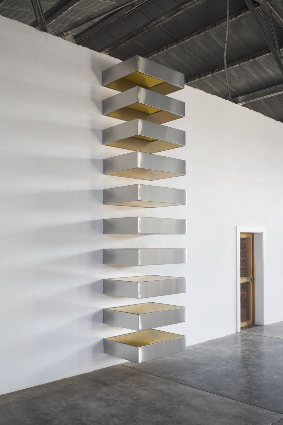 Donald Judd, Untitled, 1968, Stainless steel and yellow plexiglass, 10 units, each 9 × 40 × 31 inches. (22.9 × 101.6 × 78.7 cm), Courtesy of Judd Foundation.