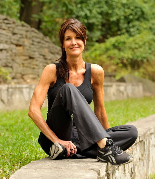 Margaret Day in running outfit sitting in the amphitheater in Toledo, OH
