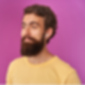Bearded man wearing yellow shirt and using white wireless earbuds on pink background.