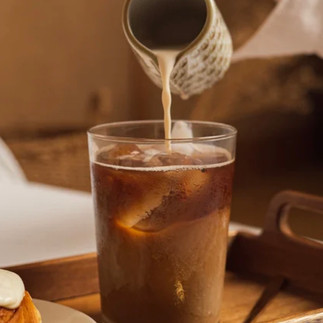milk getting poured into coffee