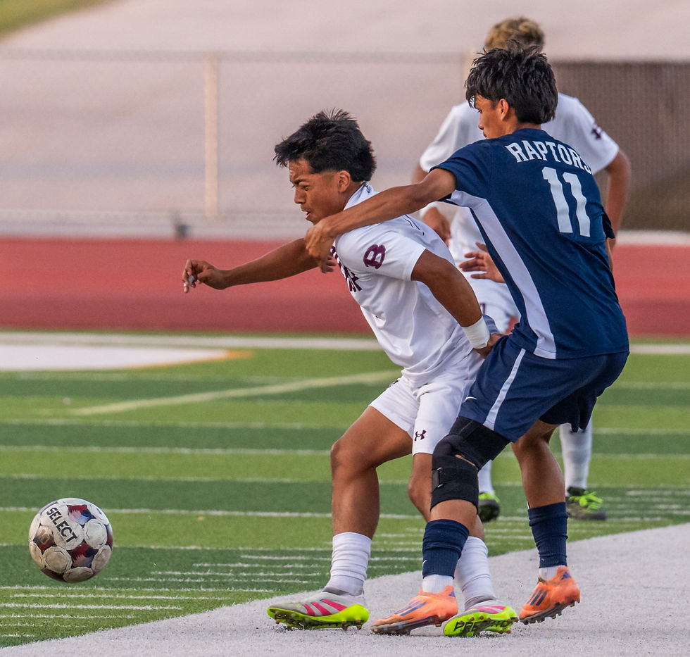 Bastrop's Anthony Reyes (left) grimaces as he battles LASA''s Jonathon Hernandez (11) for control of ball