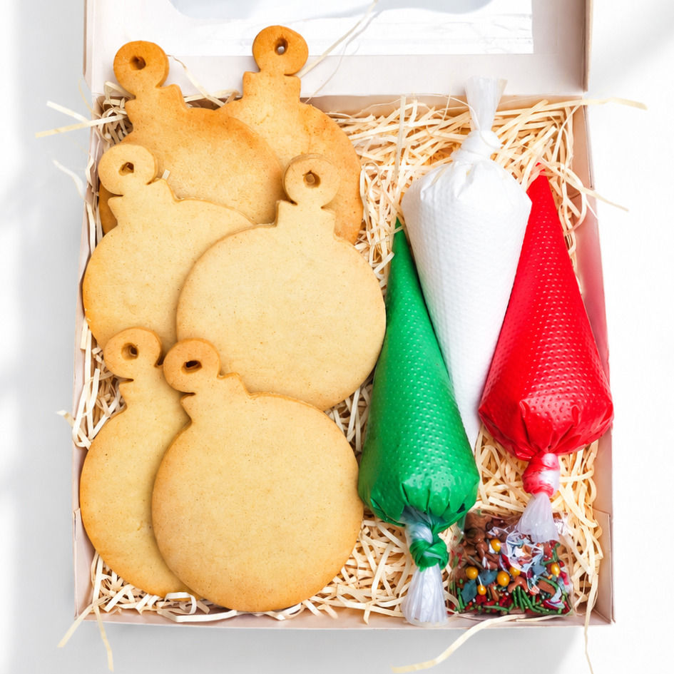 Christmas cookie kit with decorated and undecorated festive biscuits