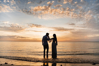 Silhouetted couple on a beach at sunset, wedding photography